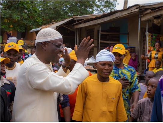 Supporters raising their hands during a walkabout through the market