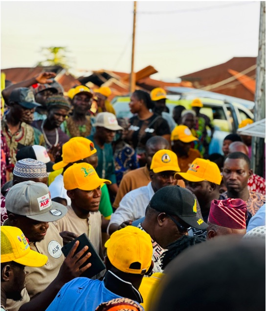 Supporters in branded campaign caps at a street gathering