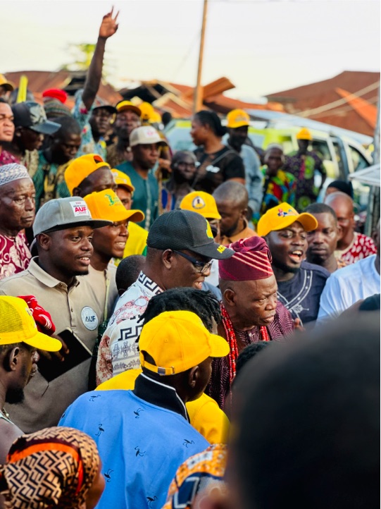 Elders and supporters gathered closely during a community visit